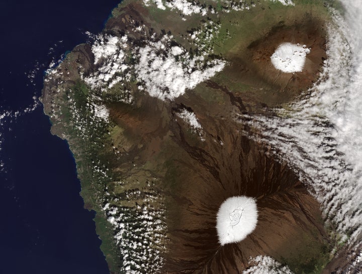 Nearly every year, snow dusts the peaks of Mauna Kea and Mauna Loa volcanoes, as seen in photo above, taken by a NASA satellite on Dec. 25, 2016.