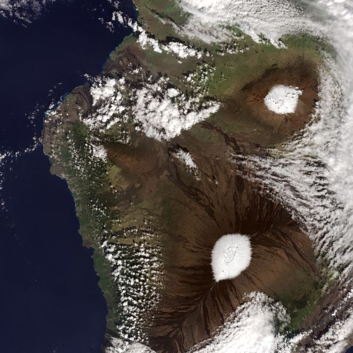 Nearly every year, snow dusts the peaks of Mauna Kea and Mauna Loa volcanoes, as seen in photo above, taken by a NASA satellite on Dec. 25, 2016.