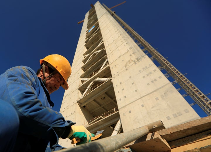 A Chinese worker is seen below a minaret at the construction site of the new Great Mosque of Algiers, which is being built by the China State Construction Engineering Corporation.