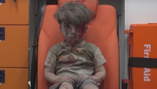 <em>Syrian child pulled from rubble</em>