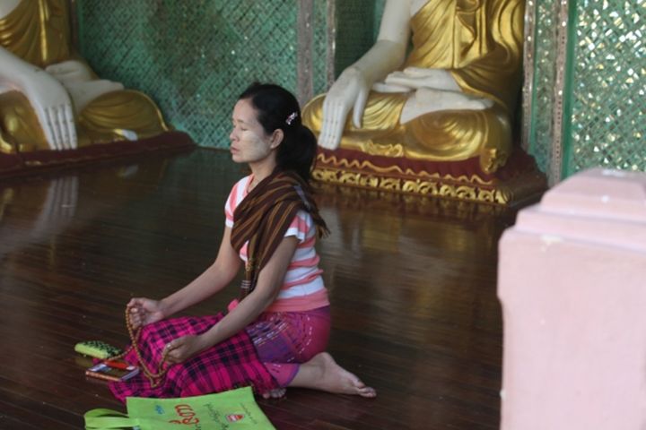 Woman praying at Buddhist temple in Taiwan