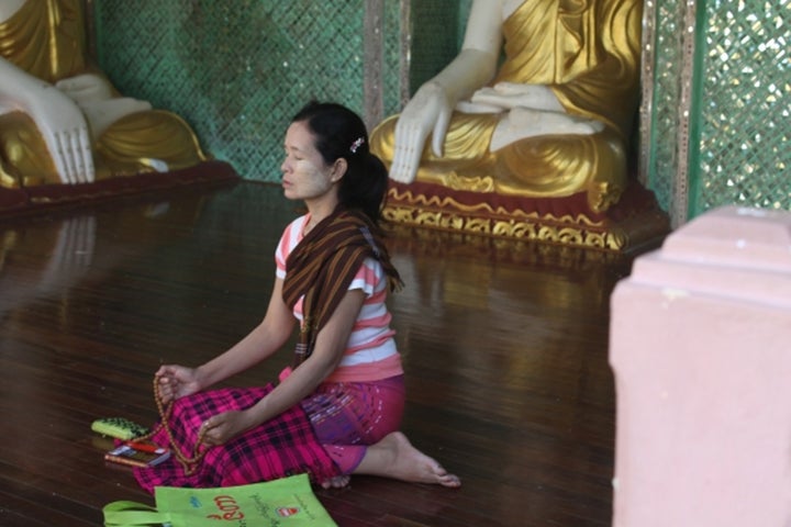 <p>Woman praying at Buddhist temple in Taiwan</p>