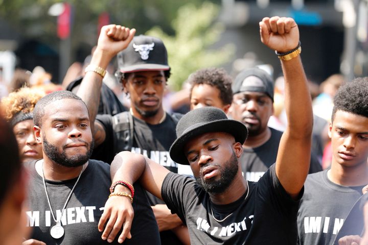 People rally outside of Bank of America stadium during an NFL game to protest the police shooting of Keith Scott in Charlotte, North Carolina.