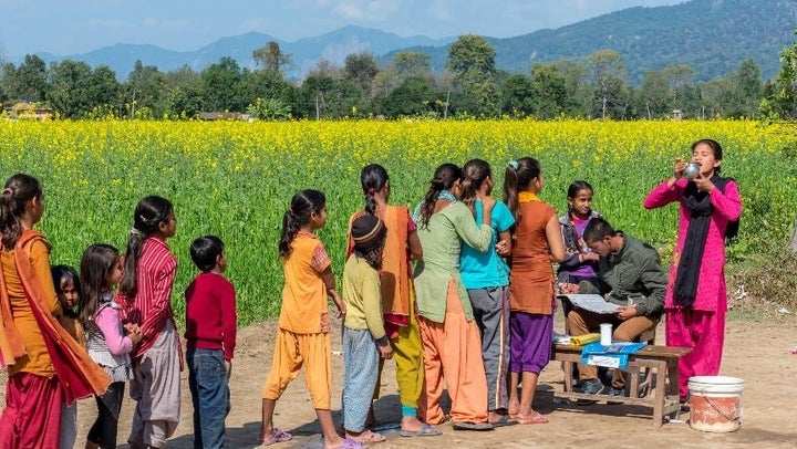 Women and girls line up during a mass treatment campaign for NTDs in Nepal. 