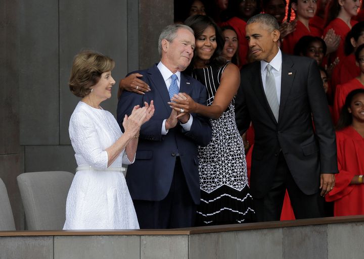 Obama hugs Bush as she arrives for the dedication of the Smithsonian’s National Museum of African American History and Culture in Washington, U.S. in September 2016.