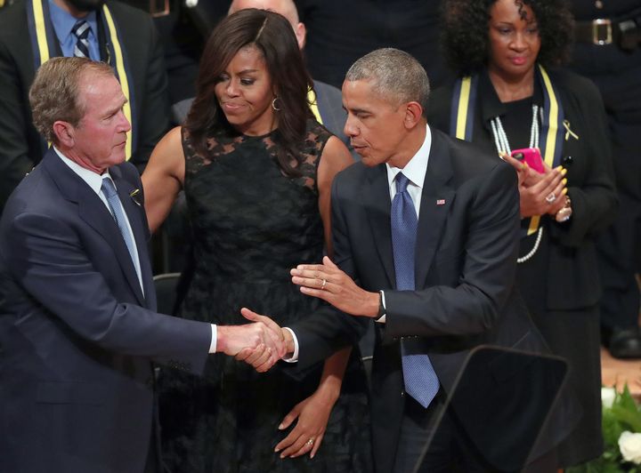 President Barack Obama and first lady Michelle Obama embrace Bush during an interfaith memorial service, honoring five slain police officer on July 12, 2016 in Dallas, Texas.
