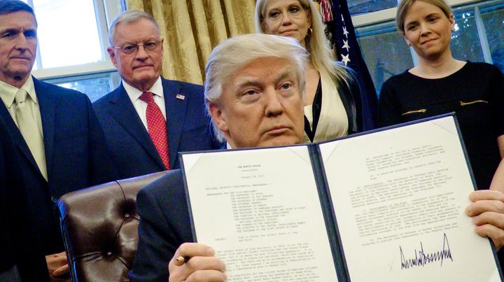President Donald Trump holds up one of the executive actions that he signed in the Oval Office on January 28. One of the actions calls on military leaders to present a report to the president in 30 days that outlines a strategy for defeating ISIS.