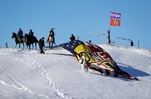 A banner is unveiled near a camp of Dakota Access pipeline protesters. Several journalists covering the Standing Rock protest