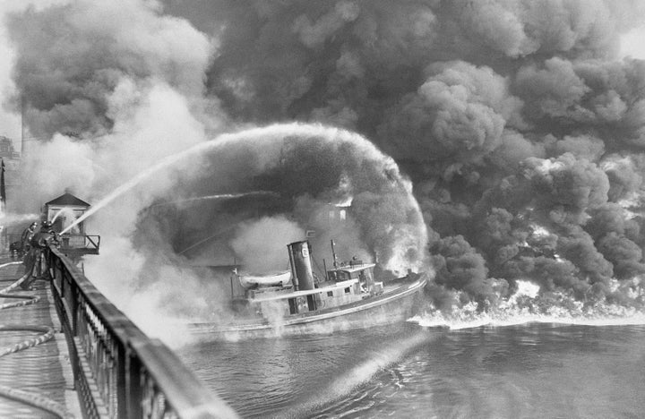 Ohio's polluted Cuyahoga River, a tributary of Lake Erie, is seen burning in 1952. The river was so clogged with waste that it burst into flames many times in the 20th century.