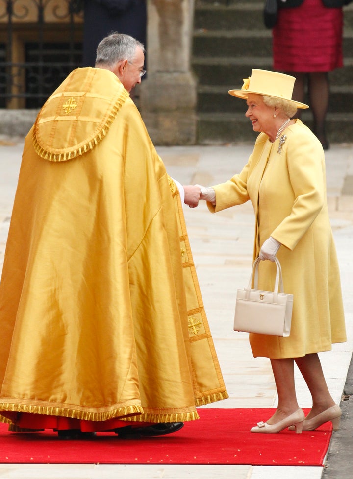 Queen Elizabeth is welcomed by the Right Reverend John Hall, Dean of Westminster as she arrives before the wedding of Britain's Prince William and Kate Middleton in central London, April 29, 2011.