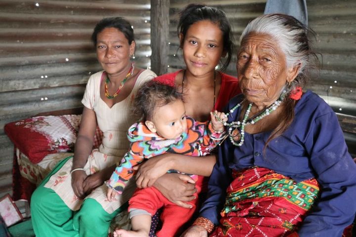 Sumina Pariyar (center), sits with her grandmother, mother and baby. Her mother and grandmother were also married at a very young age.