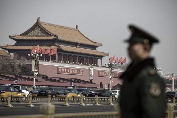 Members of the Chinese People's Armed Police stand guard at Tiananmen Square, as 3,000 lawmakers from across China desce