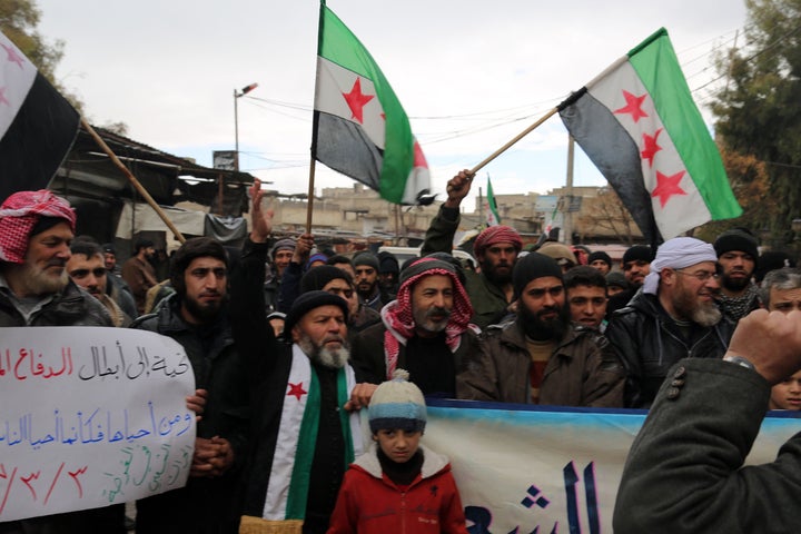 Syrians stage a protest against the Assad regime's violation of a cease-fire after Friday prayers in Damascus.