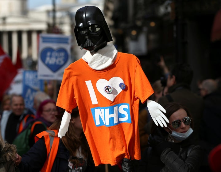 A Star Wars themed placard covered with a T-Shirt is held aloft during the NHS protest 