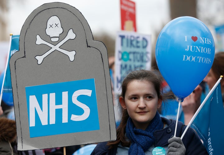 A demonstrator holds a balloon that reads 'I Love NHS Junior Doctors' during the protest