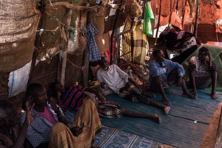 Men talk inside a tent at a camp for internally displaced people in Karin Sarmayo, Somalia.