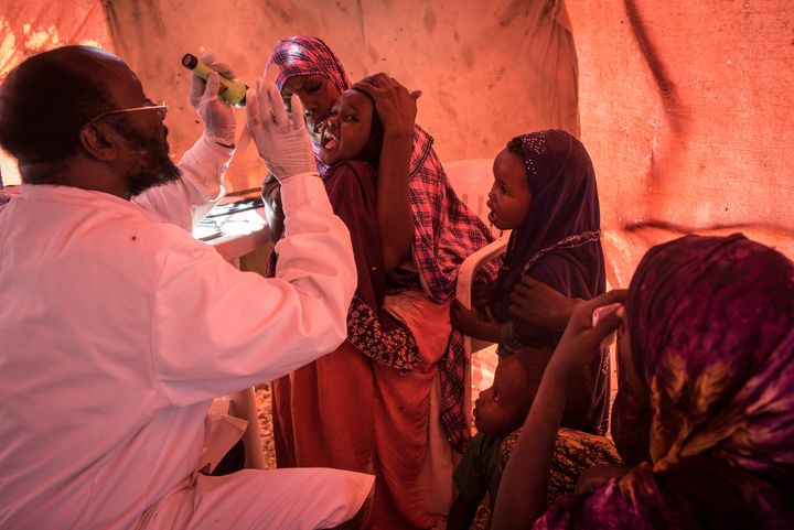 A doctor checks on a young girl at a government-run clinic inside the camp in Karin Sarmayo.