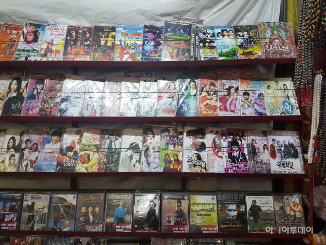 Korean drama and film CDs are on sale in a display stand in Tibetan colony. Korea is a familiar country among young Tibetans.