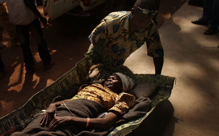 A woman is brought to a health clinic with an advanced case of rabies, Dec. 15, 2007, in Kabo in the northern Central African Republic.