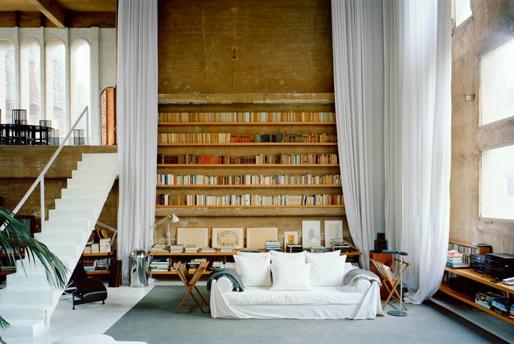 Light streams into the main living room through rows of arched windows.