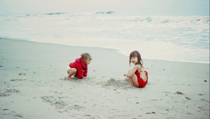 Playing at the beach with my older sister