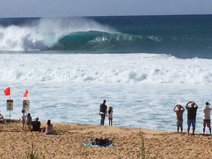 The waves break so close to shore at Banzai-Pipeline you can photograph a surfer in a curl with a cell phone.