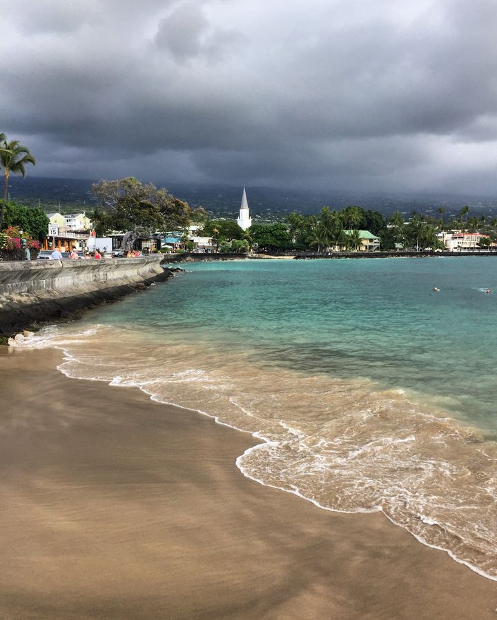 <p>The town of Kailua occupies one side of the street, the bay the other.</p>