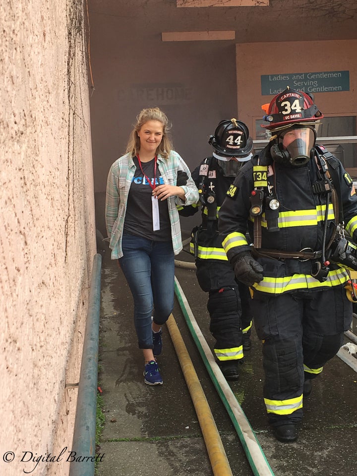 <p>A UC Davis Fire Department EMT student gets escorted out of the building after being located by firefighters</p>