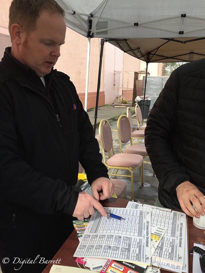 AMR paramedic Scott Gowin goes over the triage sheet, making sure all of his patients are recorded and accounted for.