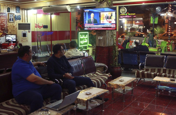 Men watch the TV news in Baghdad, Iraq, on March 6, 2017.