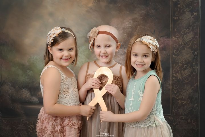 This year, the girls held a gold ribbon for childhood cancer awareness.