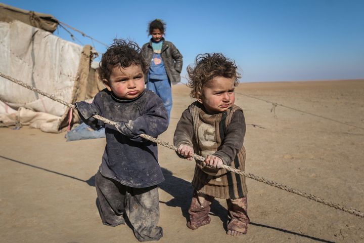 Syrian children who fled Raqqa city stand near their tent in Ras al-Ain province, Syria January 22. The psychological toll placed on minors is 'enormous', Save The Children is warning