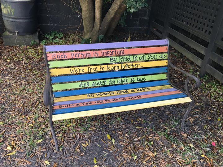 This bench is outside a nursery school. We could all use to learn from it. “All people need a voice.”