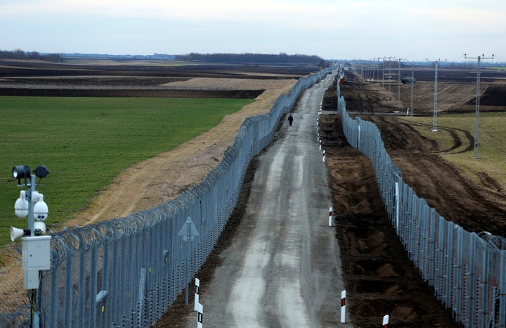 A Hungarian policeman patrols the Hungary-Serbia border, which was recently fortified by a second fence, near the village of Gara, Hungary March 2, 2017.