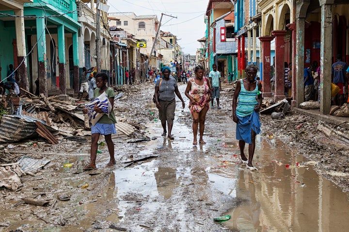 <p>Residents in the Haitian city of Les Cayes on the streets two days after Hurricane Matthew, a category 4 storm, made landfall in the country on 4 October 2016.</p>