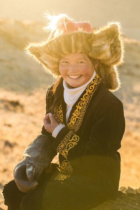 Aisholpan in traditional Mongolian dress with eagle hunt glove