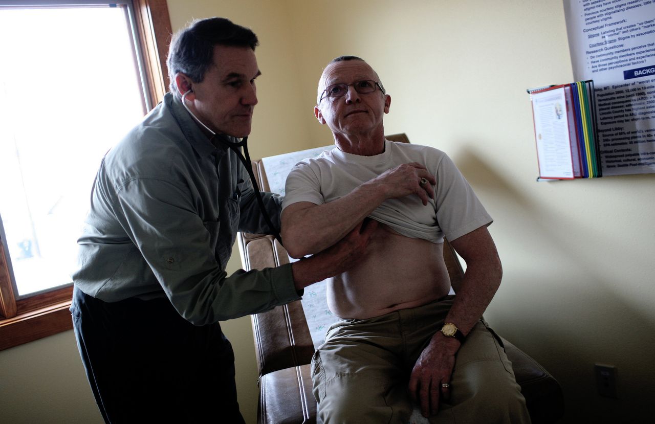 Dr. Brad Black, the CEO of Libby's Center for Asbestos Related Disease, checks one of his patients, Thomas Creighton.