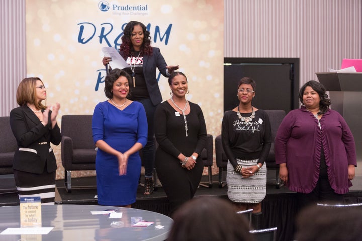 The audience cheers on the entrepreneurs who pitched their business during the Elevator Pitch Competition. Nicole (in blue) w