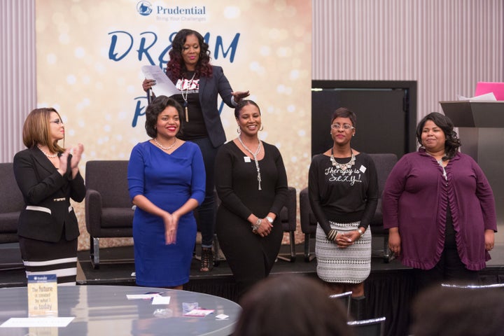 The audience cheers on the entrepreneurs who pitched their business during the Elevator Pitch Competition. Nicole (in blue) was the first place winner.