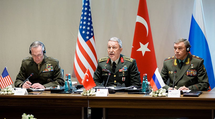 Turkish Chief of General Staff Gen. Hulusi Akar (C) speaks along with his American and Russian counterparts at a meeting in A