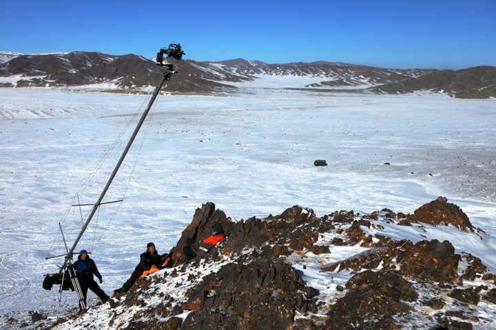 Film crew on Mongolian cliff: Ben Crossley, Camera Assistant; Simon Niblett, DP; & Otto Bell, Director