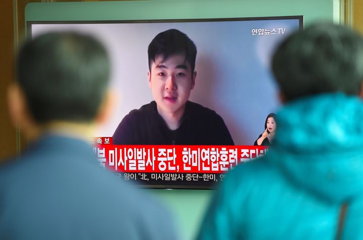 South Koreans watch a television news showing a video footage of a man who claims he is Kim Han-Sol