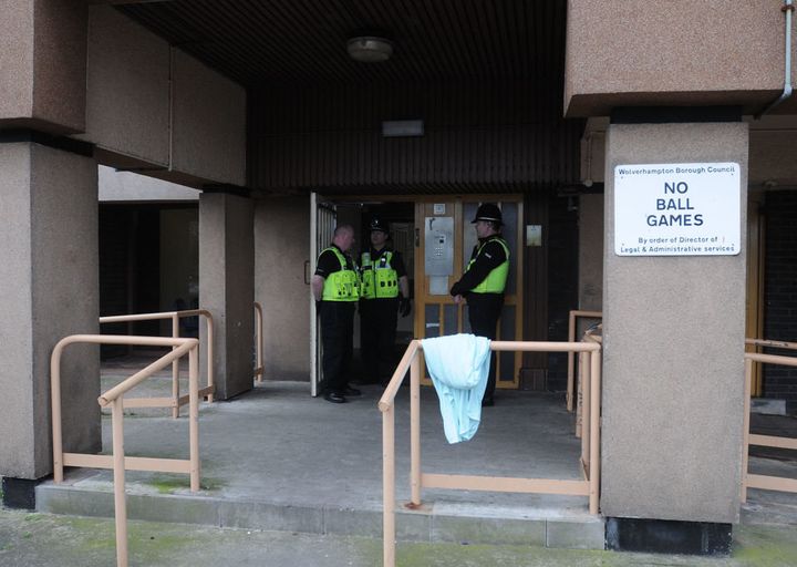Police outside the block of flats after the incident