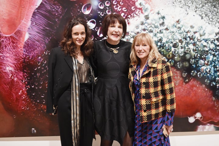 Marilyn Minter (center) and Cindy Sherman (right) in front of Minter's work.