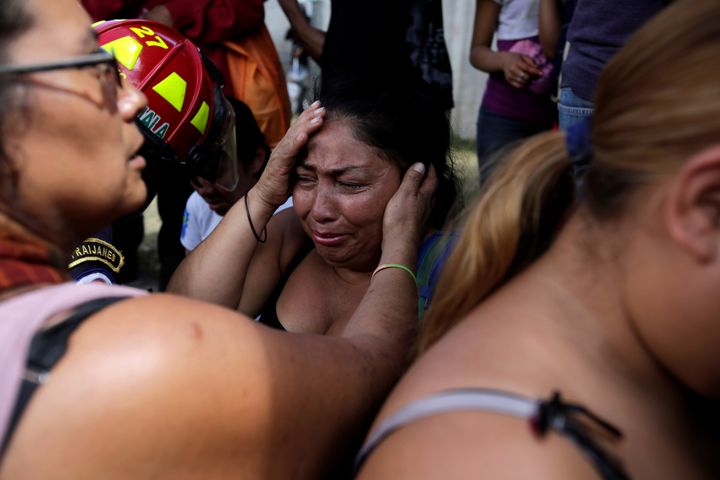 Family members react as they wait for news of their loved ones after a fire broke at the Virgen de Asuncion home in San Jose Pinula, on the outskirts of Guatemala City, Guatemala March 8, 2017.