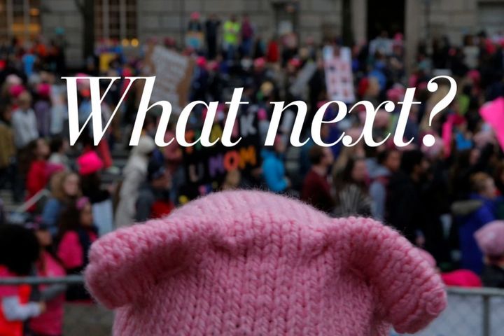 A woman wearing a pink hat, a symbol of protest, watches the Women’s March on Washington, a day after the inauguration of President Trump, on Jan. 21, 2017. (Brian Snyder/Reuters)