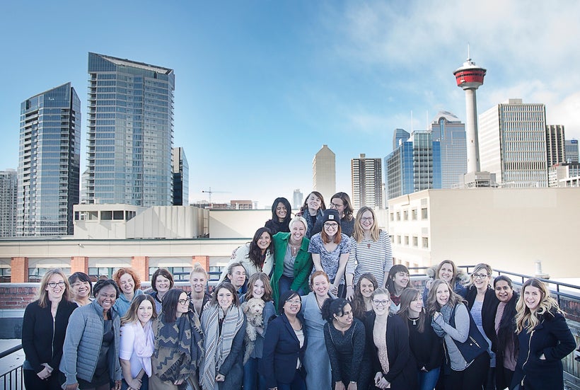 A handful of Benevity's women gather on the rooftop of the Pilkington Building in Calgary for International Women's Day (It w