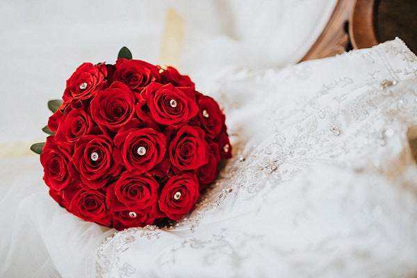 Opt for a classic red rose bouquet. <em>Related: <a href="http://www.bridalguide.com/planning/the-details/decor-flowers/unique-red-roses#169574" target="_blank" role="link" rel="nofollow" class=" js-entry-link cet-external-link" data-vars-item-name="15 Unique Ways to Use Red Roses in Your Wedding" data-vars-item-type="text" data-vars-unit-name="58c0aaaee4b0a797c1d398f0" data-vars-unit-type="buzz_body" data-vars-target-content-id="http://www.bridalguide.com/planning/the-details/decor-flowers/unique-red-roses#169574" data-vars-target-content-type="url" data-vars-type="web_external_link" data-vars-subunit-name="article_body" data-vars-subunit-type="component" data-vars-position-in-subunit="8">15 Unique Ways to Use Red Roses in Your Wedding</a></em>