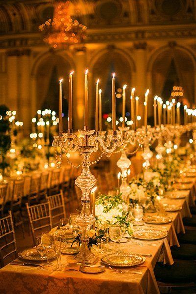Line your tables with candelabras and gilded touches that would make Lumière proud. Related: Beyond Flowers: 50 Unique Ideas for Your Centerpieces