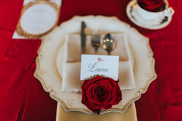 Dress up each place setting with a single red rose. <em>Related: <a href="http://www.bridalguide.com/planning/the-details/reception/escort-cards#157757" target="_blank" role="link" rel="nofollow" class=" js-entry-link cet-external-link" data-vars-item-name="35 Cool Ways to Display Your Escort Cards" data-vars-item-type="text" data-vars-unit-name="58c0aaaee4b0a797c1d398f0" data-vars-unit-type="buzz_body" data-vars-target-content-id="http://www.bridalguide.com/planning/the-details/reception/escort-cards#157757" data-vars-target-content-type="url" data-vars-type="web_external_link" data-vars-subunit-name="article_body" data-vars-subunit-type="component" data-vars-position-in-subunit="22">35 Cool Ways to Display Your Escort Cards</a></em>